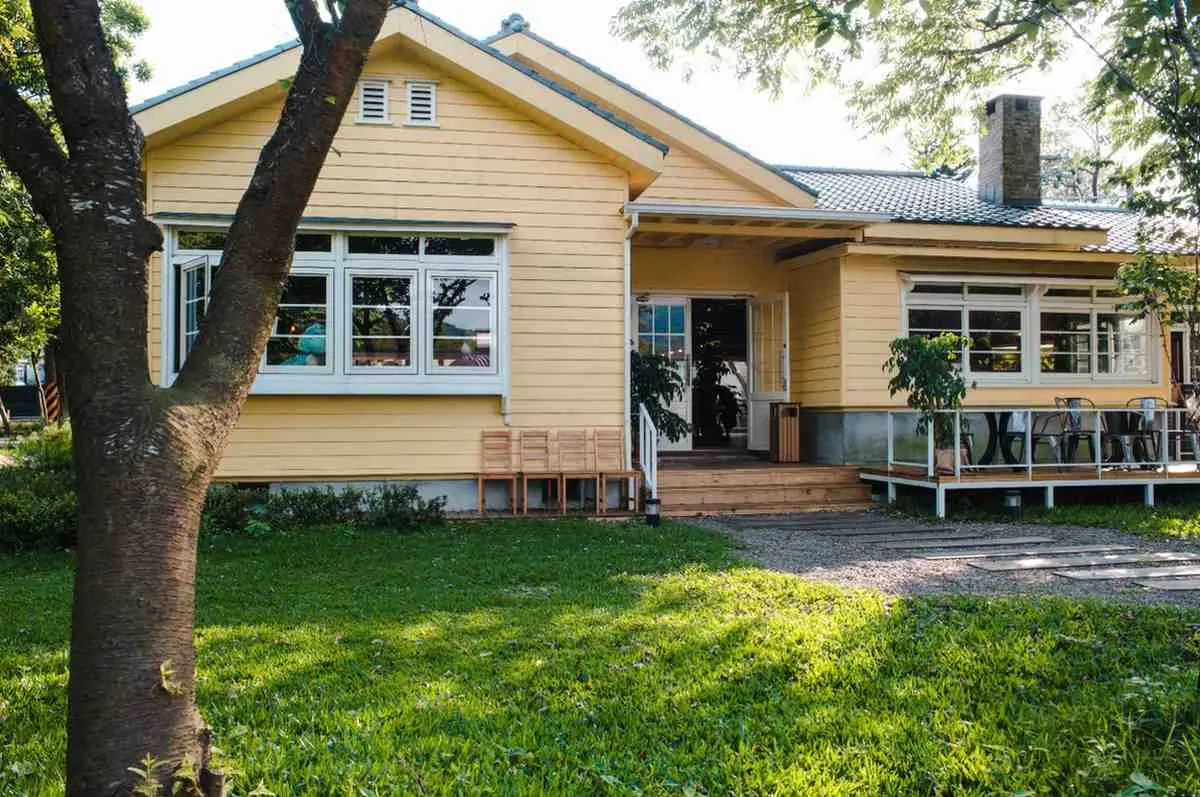House exterior with a front lawn and covered porch